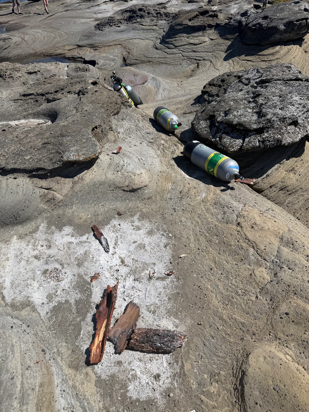 Dive tanks staged on sandstone at a Nanaimo shore entry